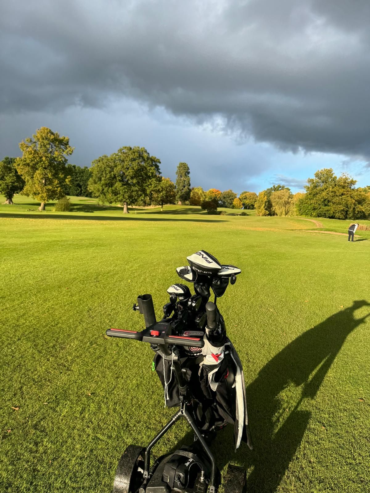 Golf bag on trolley with fairway ahead