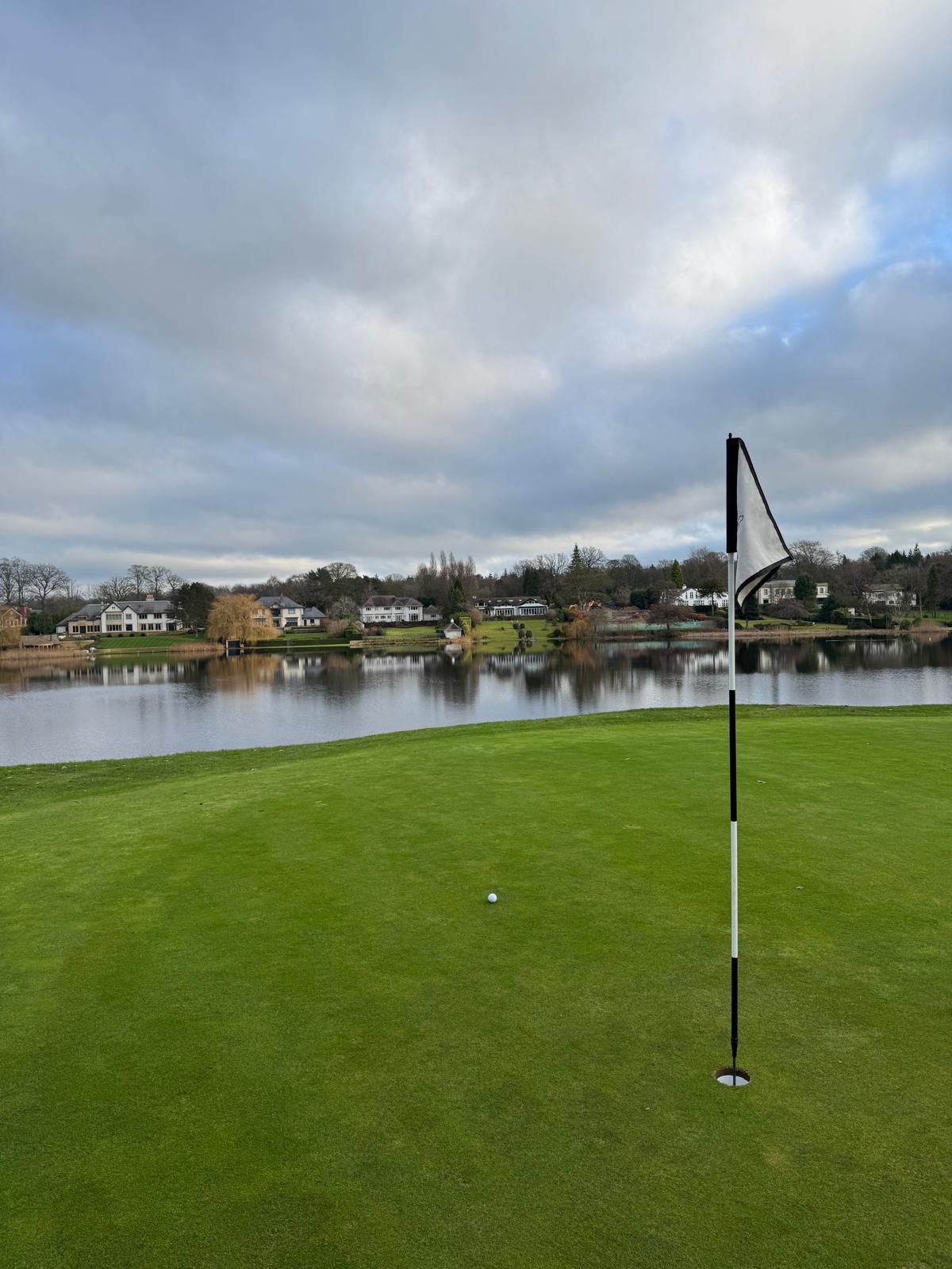Green with flag and lake beyond